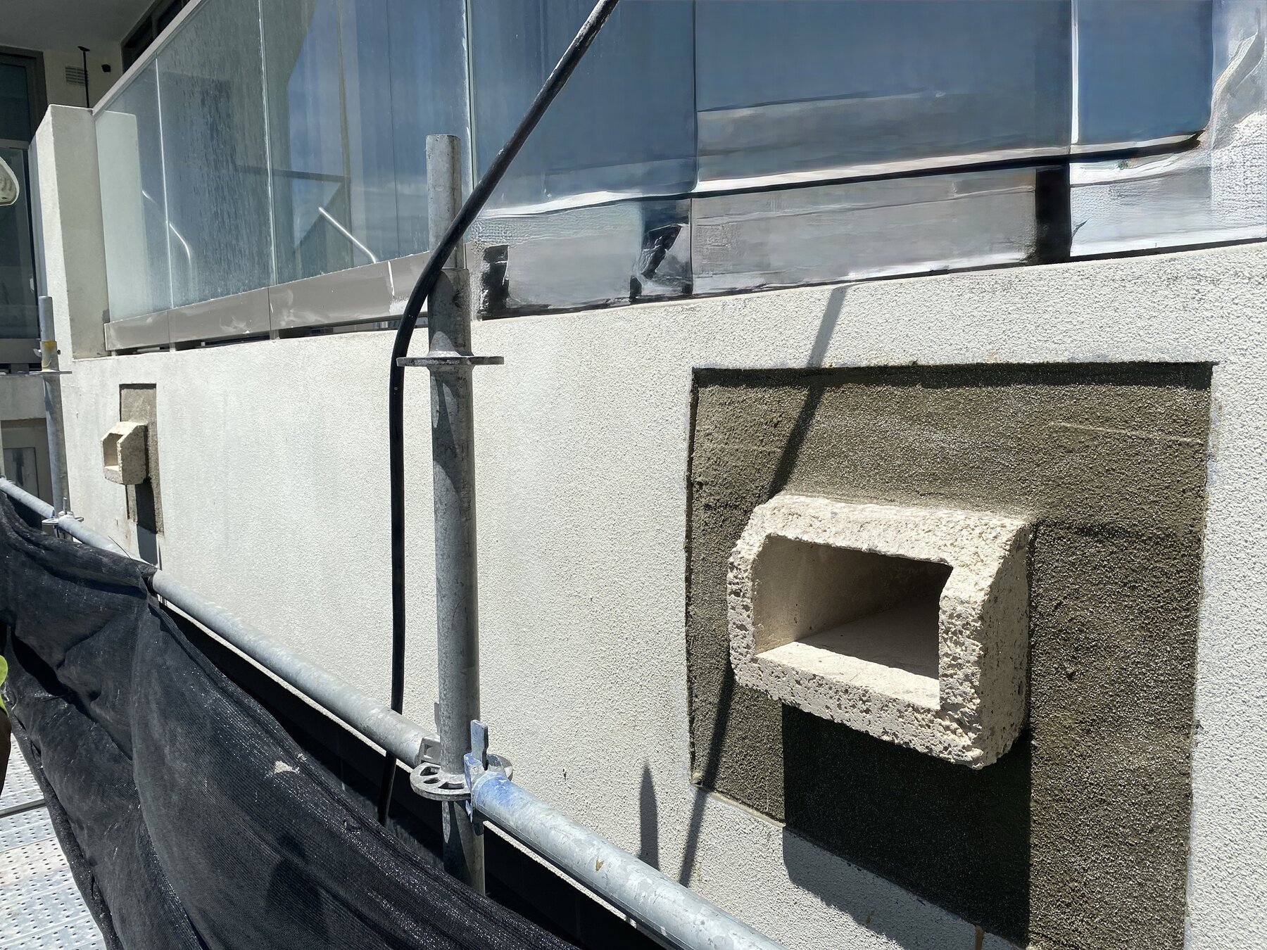 Stucco and restoration detail work on high-rise balcony